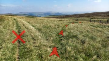 A photo of step 4 of the Axe Edge Walk route, with red arrows superimposed to show the way.