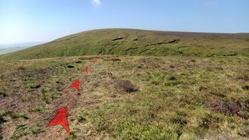 A photo of step 7 of the Axe Edge Walk route, with red arrows superimposed to show the way.