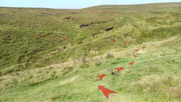 A photo of step 9 of the Axe Edge Walk route, with red arrows superimposed to show the way.