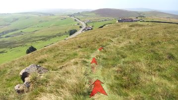A photo of step 16 of the Axe Edge Walk route, with red arrows superimposed to show the way.