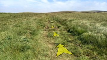 A photo of step 27 of the Axe Edge Walk route, with yellow arrows superimposed to show the way.