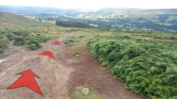 A photo of step 15 of the Bamford Edge Walk route, with red arrows superimposed to show the way.