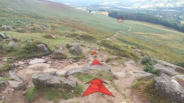 A photo of step 16 of the Bamford Edge Walk route, with red arrows superimposed to show the way.