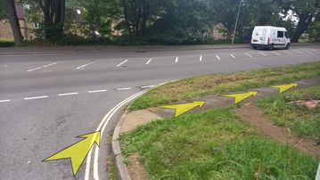 A photo of step 22 of the Bamford Edge Walk route, with yellow arrows superimposed to show the way.