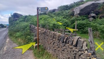 A photo of step 19 of the Burbage Rocks & Higger Tor Walk route, with yellow arrows superimposed to show the way.