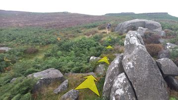A photo of step 21 of the Burbage Rocks & Higger Tor Walk route, with yellow arrows superimposed to show the way.
