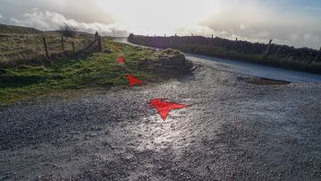 A photo of step 1 of the Cats Tor Walk route, with red arrows superimposed to show the way.
