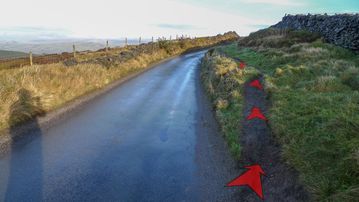 A photo of step 3 of the Cats Tor Walk route, with red arrows superimposed to show the way.