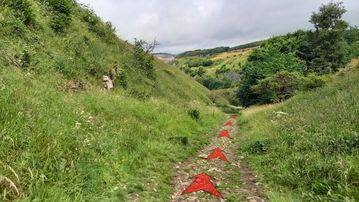 A photo of step 3 of the Chee Dale Walk route, with red arrows superimposed to show the way.