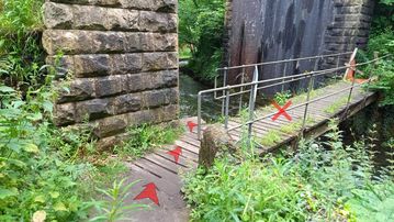A photo of step 8 of the Chee Dale Walk route, with red arrows superimposed to show the way.