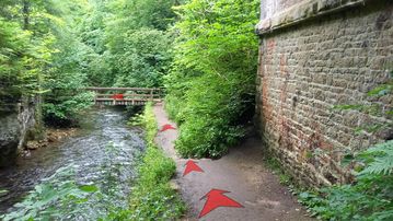 A photo of step 15 of the Chee Dale Walk route, with red arrows superimposed to show the way.