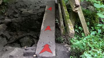 A photo of step 21 of the Chee Dale Walk route, with red arrows superimposed to show the way.