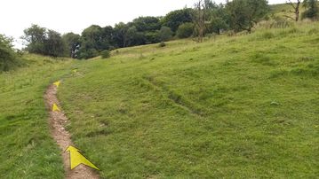 A photo of step 26 of the Chee Dale Walk route, with yellow arrows superimposed to show the way.