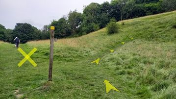 A photo of step 27 of the Chee Dale Walk route, with yellow arrows superimposed to show the way.