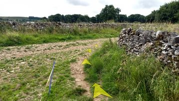 A photo of step 33 of the Chee Dale Walk route, with yellow arrows superimposed to show the way.