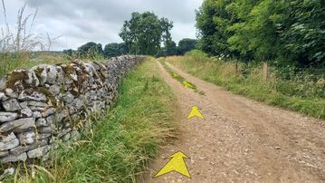 A photo of step 34 of the Chee Dale Walk route, with yellow arrows superimposed to show the way.