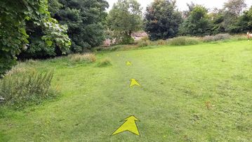 A photo of step 38 of the Chee Dale Walk route, with yellow arrows superimposed to show the way.