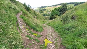 A photo of step 45 of the Chee Dale Walk route, with yellow arrows superimposed to show the way.