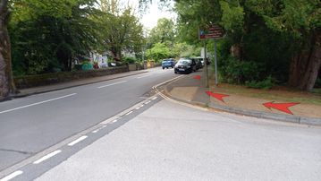A photo of step 1 of the Corbar Hill Walk route, with red arrows superimposed to show the way.
