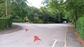 A photo of step 4 of the Corbar Hill Walk route, with red arrows superimposed to show the way.