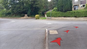 A photo of step 5 of the Corbar Hill Walk route, with red arrows superimposed to show the way.