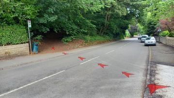 A photo of step 6 of the Corbar Hill Walk route, with red arrows superimposed to show the way.