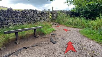 A photo of step 14 of the Corbar Hill Walk route, with red arrows superimposed to show the way.