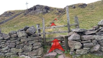 A photo of step 16 of the Corbar Hill Walk route, with red arrows superimposed to show the way.