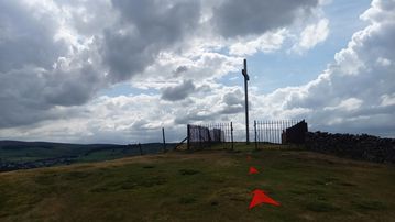 A photo of step 17 of the Corbar Hill Walk route, with red arrows superimposed to show the way.