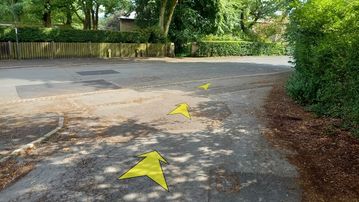 A photo of step 23 of the Corbar Hill Walk route, with yellow arrows superimposed to show the way.