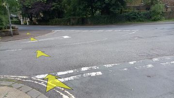 A photo of step 24 of the Corbar Hill Walk route, with yellow arrows superimposed to show the way.