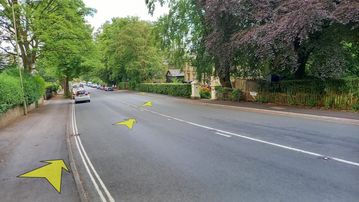 A photo of step 25 of the Corbar Hill Walk route, with yellow arrows superimposed to show the way.