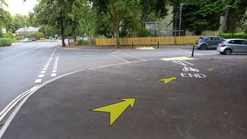 A photo of step 26 of the Corbar Hill Walk route, with yellow arrows superimposed to show the way.