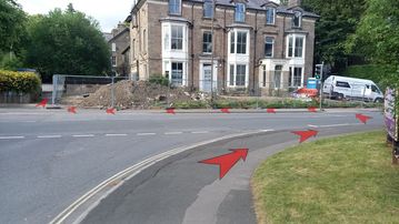 A photo of step 2 of the Corbar Hill Walk route, with red arrows superimposed to show the way.