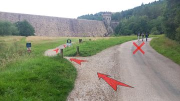 A photo of step 3 of the Derwent Reservoir Walk route, with red arrows superimposed to show the way.