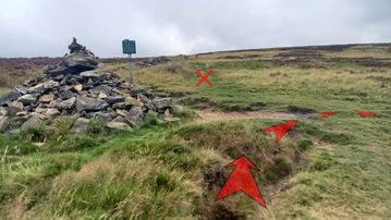 A photo of step 17 of the Derwent Reservoir Walk route, with red arrows superimposed to show the way.