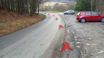 A photo of step 1 of the Fernilee Reservoir Walk route, with red arrows superimposed to show the way.