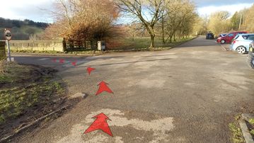 A photo of step 8 of the Fernilee Reservoir Walk route, with red arrows superimposed to show the way.