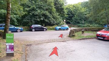 A photo of step 1 of the Kinder Reservoir Walk route, with red arrows superimposed to show the way.