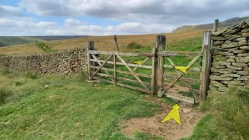 A photo of step 15 of the Kinder Reservoir Walk route, with yellow arrows superimposed to show the way.