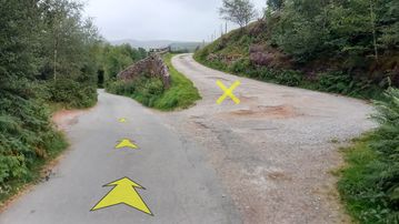 A photo of step 36 of the Lud's Church Walk route, with yellow arrows superimposed to show the way.