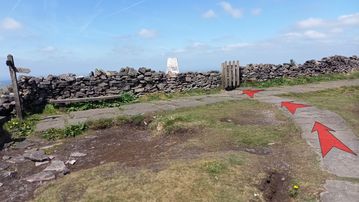 A photo of step 9 of the Shining Tor Walk route, with red arrows superimposed to show the way.