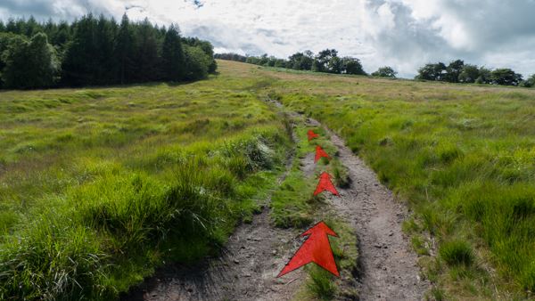 A photo of step 4 of the Shining Tor route, with red arrows superimposed to show the way.
