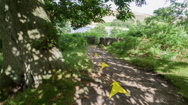 A photo of step 13 of the Shining Tor route, with yellow arrows superimposed to show the way.