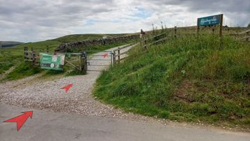 A photo of step 2 of the Shutlingsloe Walk route, with red arrows superimposed to show the way.