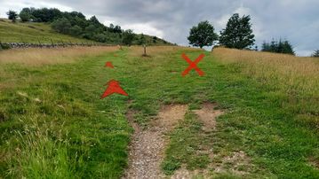 A photo of step 4 of the Shutlingsloe Walk route, with red arrows superimposed to show the way.