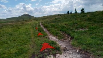 A photo of step 11 of the Shutlingsloe Walk route, with red arrows superimposed to show the way.