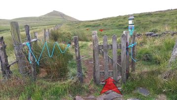 A photo of step 12 of the Shutlingsloe Walk route, with red arrows superimposed to show the way.