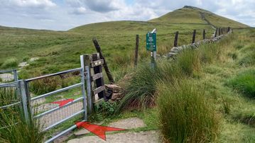 A photo of step 15 of the Shutlingsloe Walk route, with red arrows superimposed to show the way.