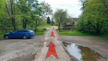 A photo of step 1 of the Three Shires Head Walk route, with red arrows superimposed to show the way.